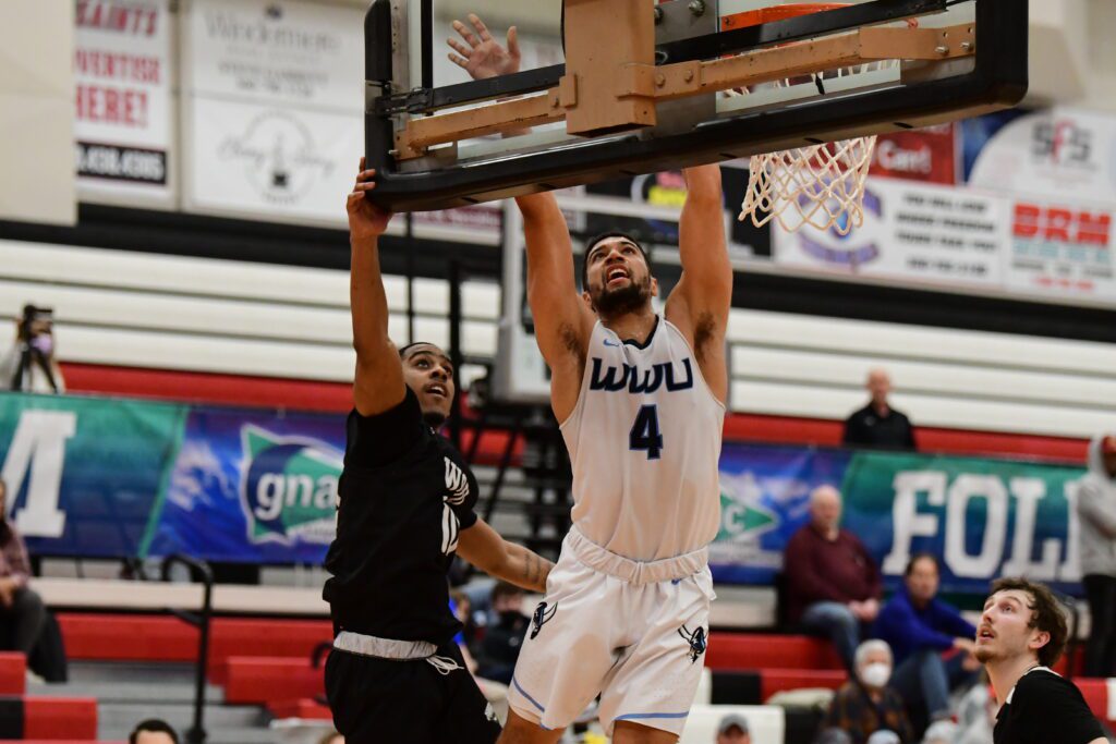 Western senior guard RJ Secrest of Bremerton drives to the hoop with a defender behind him.