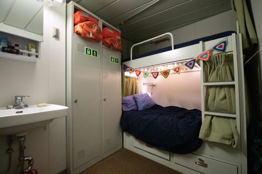 Decorations hang over the bottom bunk inside the sleeping quarters on the Joint Oceanographic Institutions for Deep Earth Sampling (JOIDES) Resolution.