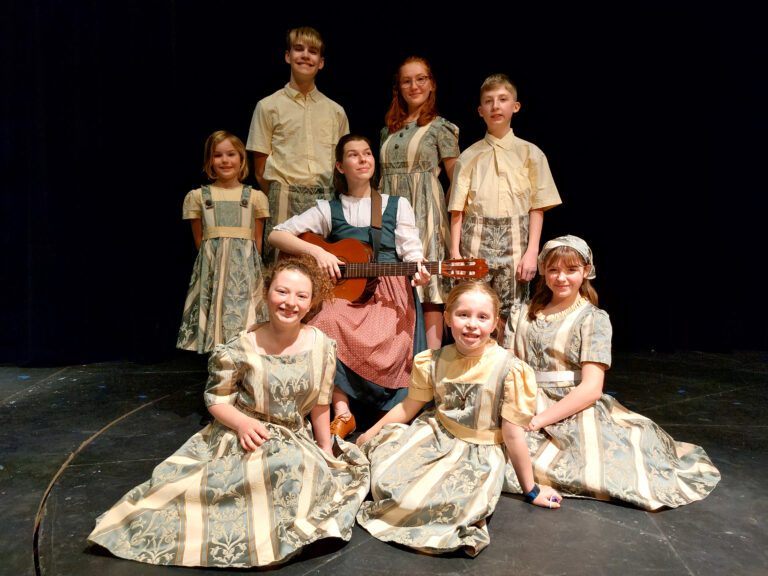 Skagit Valley College Music Department presents “The Sound of Music” as the cast takes a group photo on stage with their costumes.