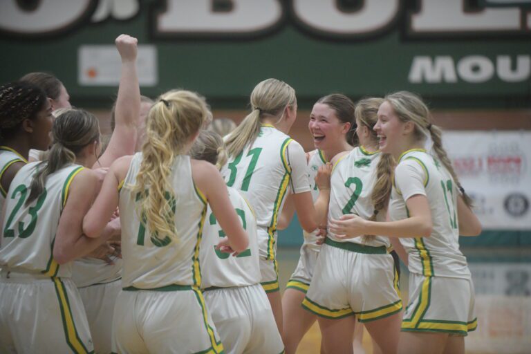 Lynden players celebrate in a crowded huddle.