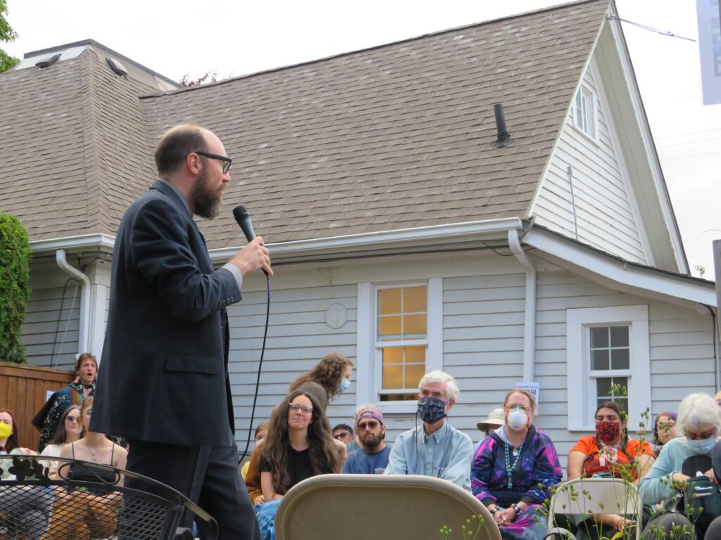 Lawyer Daniel Hornal discusses potential mass action lawsuits with the seated crowd.