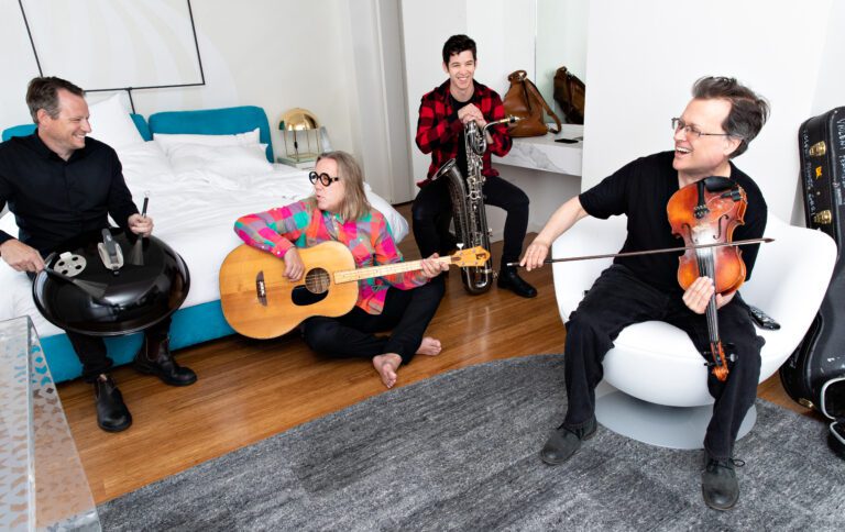 Violent Femmes cofounders Gordon Gano (far right) and Brian Ritchie (second from left) practice with their respective instruments.