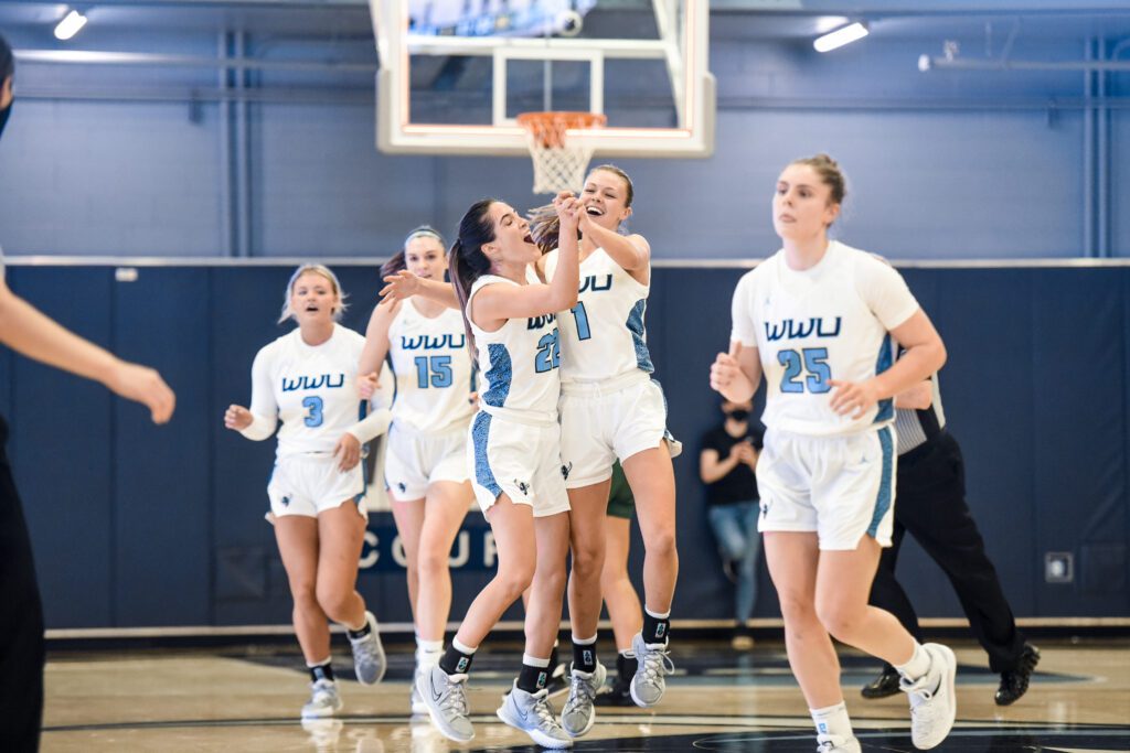 Western's women's hoops squad celebrates with hugs and cheers.