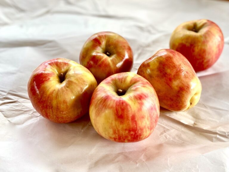 Apples placed on a marble counter.