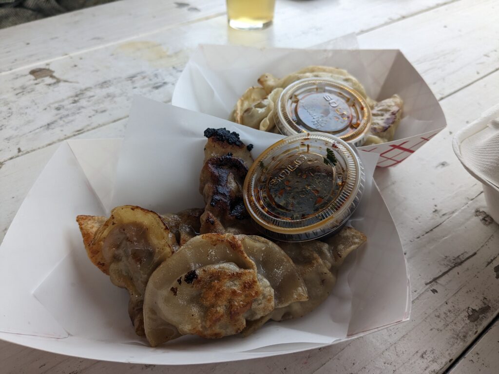 Vegetable dumplings are loaded with a slaw-like mixture of crisp vegetables alongside the beef dumplings served with the same sauce on the side.