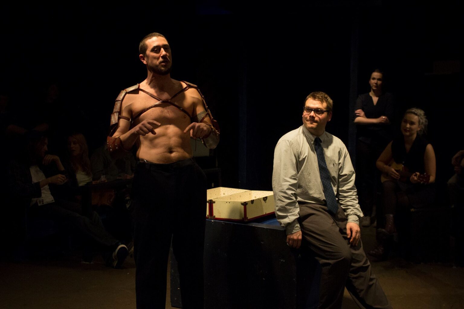 Ben Eisner (left) and Andrew Herndon in a dark room underneath a dim light.