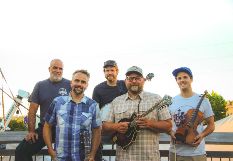 High Mountain String Band poses for a photo with their respective instruments.