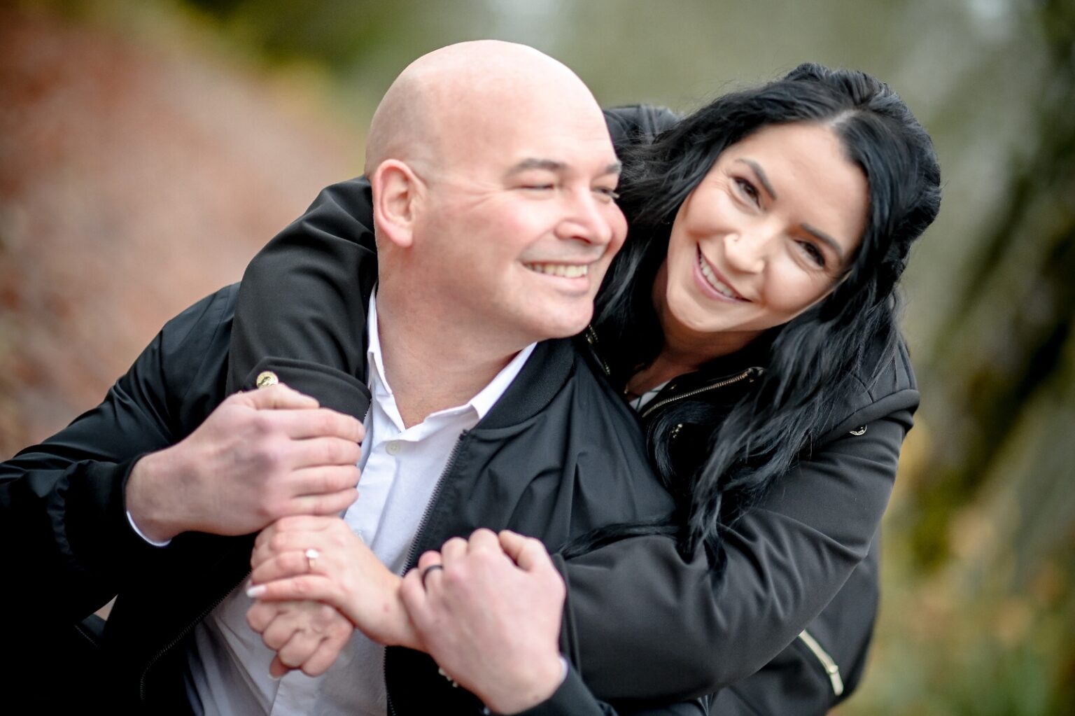 Ryan Rathbun and wife Jessica Lawson hug inside their home.