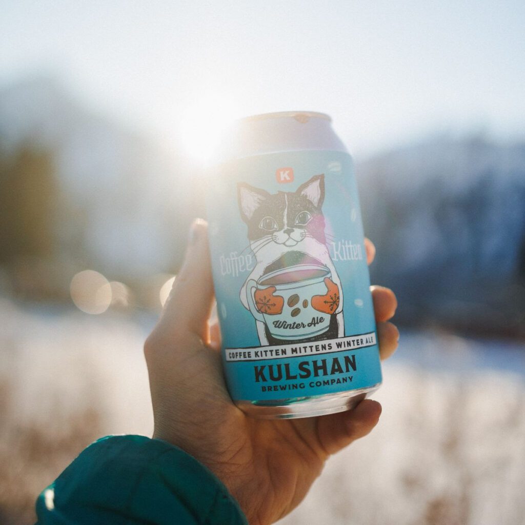 A person holds up Kulshan Brewing Company's canned ale.