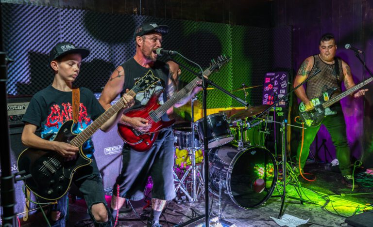 Proud Failures are joined onstage by guitarist and vocalist Kent Leath's son Zach with a green light shining on the stage.