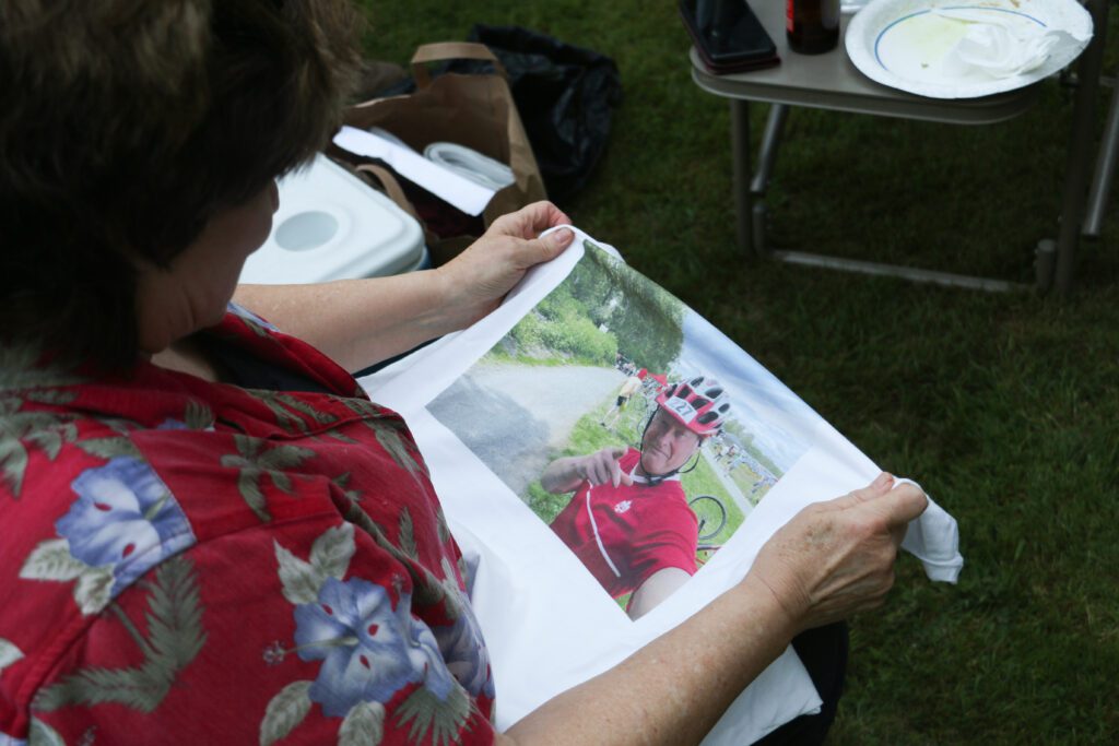 During the team's pre-race meeting, sea kayak racer Dawn Groves looks at the team T-shirt, which features the last photo Rob Lawrance's selfie.