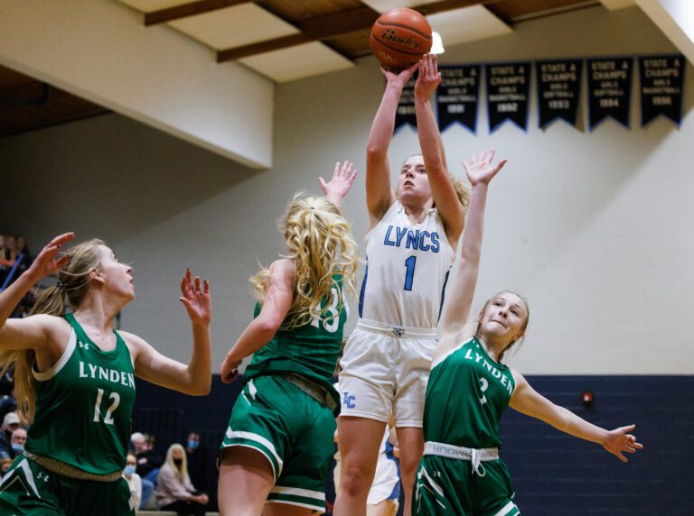 Lynden Christian’s Libby Stump hits a jump shot over Lynden defenders.