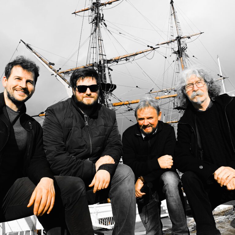 Iain MacGillivray, left, Malcolm Bushby, Phil Smillie and Roy Gullane of The Tannahill Weavers pose in front of a ship.