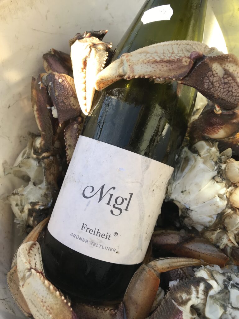 Wine placed in a bucket full of crab.