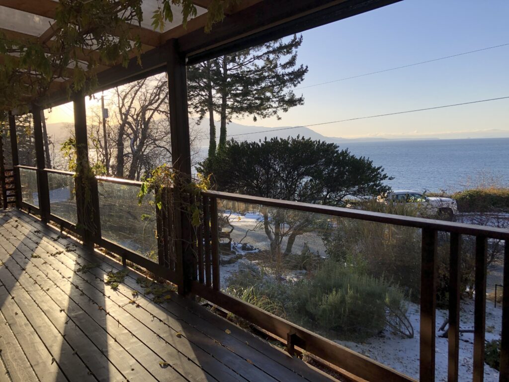 The outdoor veranda of The Willows shows the beachfront of the expansive ocean,