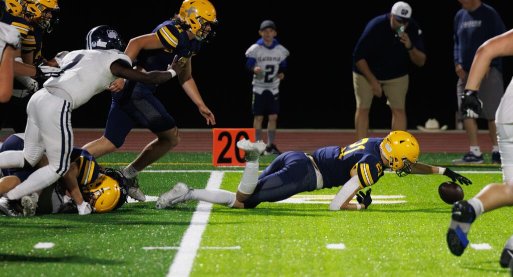 Ferndale’s Aydin O'Tool dives on a fumble, leaving a trail of defenders on the grass behind him.