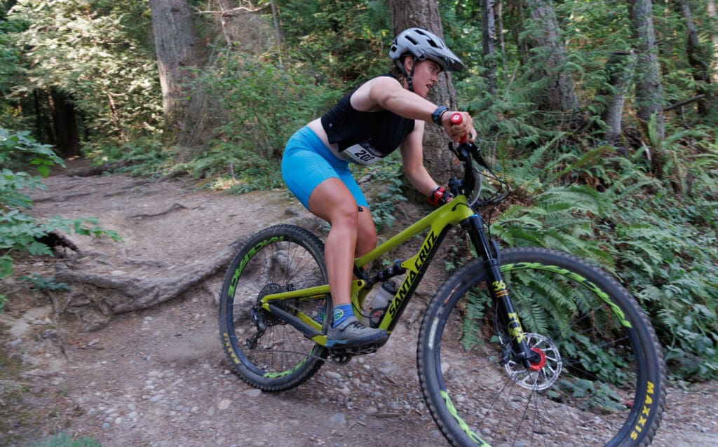 A biker from The Old, The Young, and The Baddass makes the final descent in the mountain bike leg.