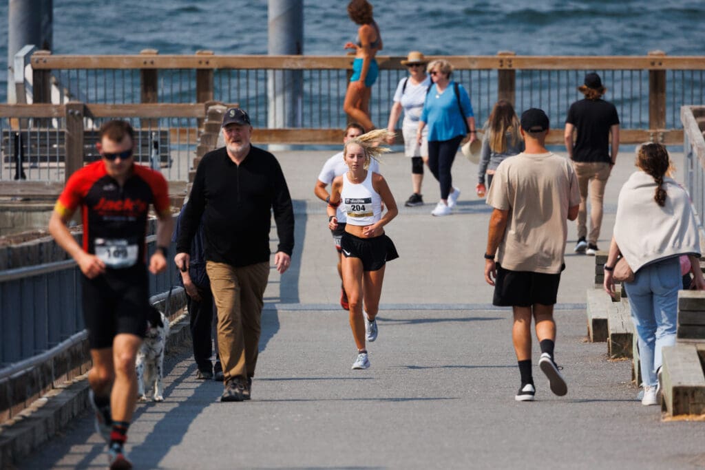 Runners make their way around the through walkers along Taylor Dock.