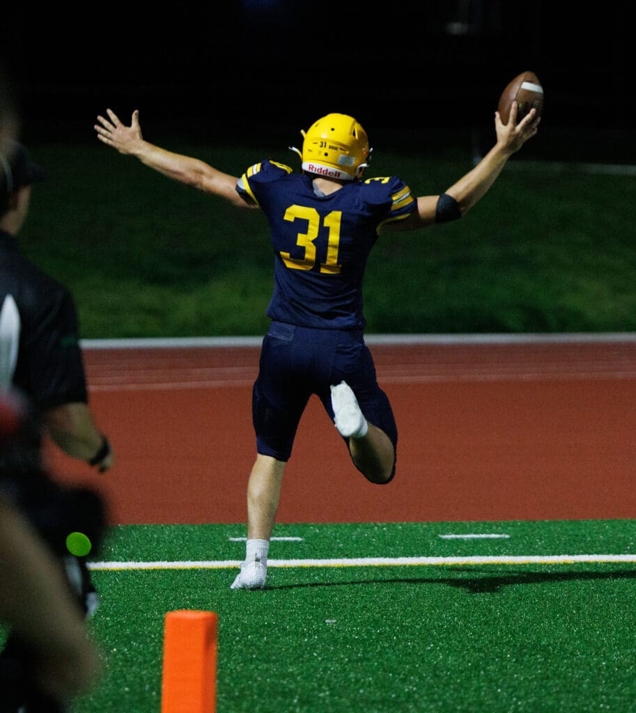 Ferndale's Talan Bungard celebrates a touchdown with his arms in the air.