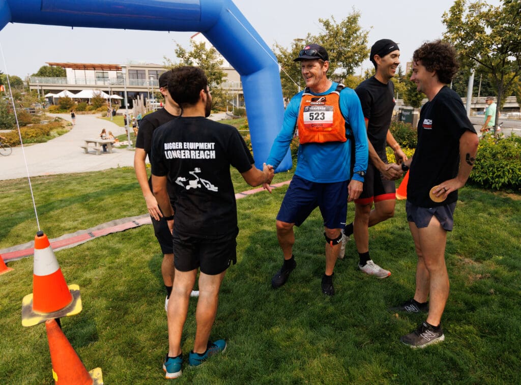 Birch Equipment teammates shake hands after winning the Bellingham Traverse relay race.