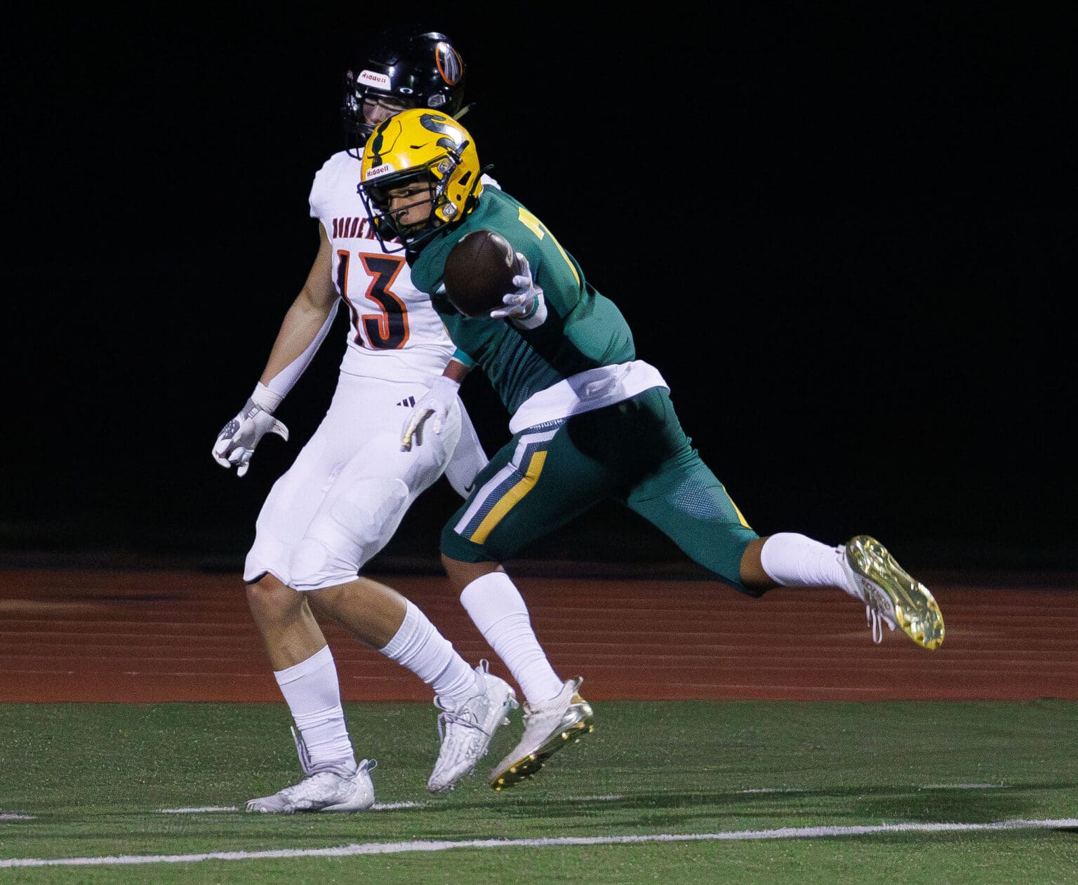 After keeping both feet in play, Sehome's Andre Watson leaps and holds the ball back as a defender stops in his tracks next to him.