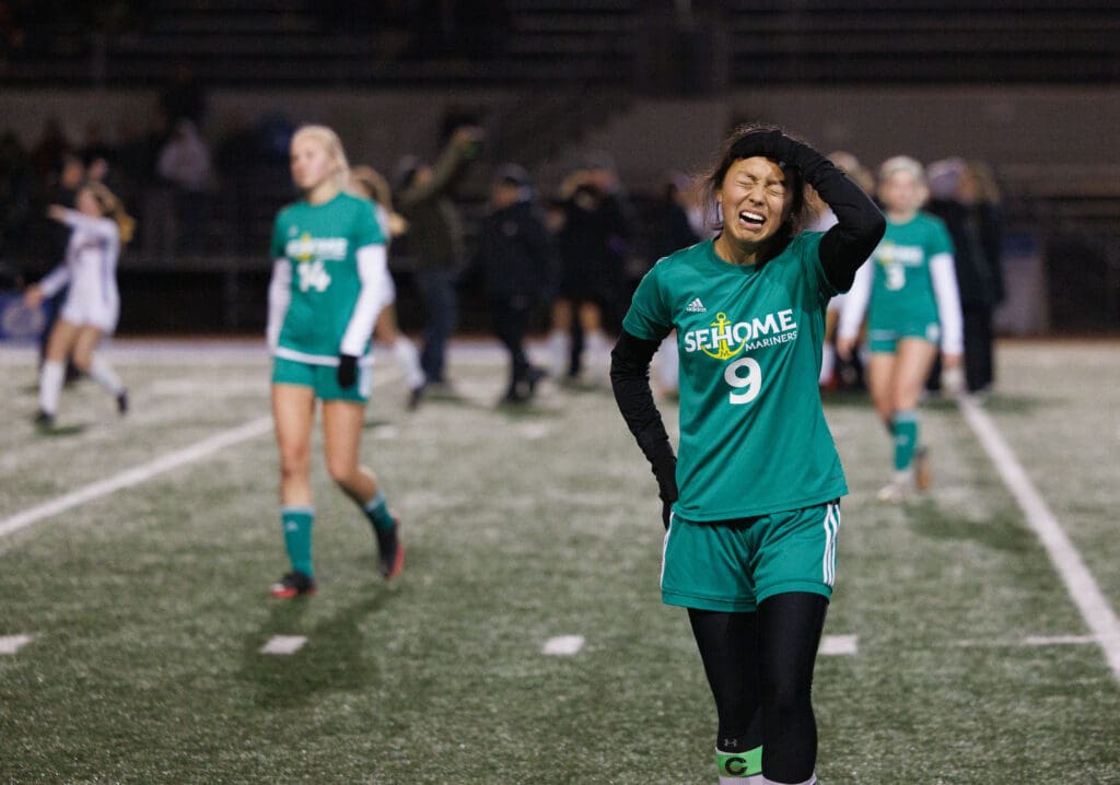 As the whistle sounds, Sehome’s Evelyn Keay reacts to the loss with a hand on her forehead.