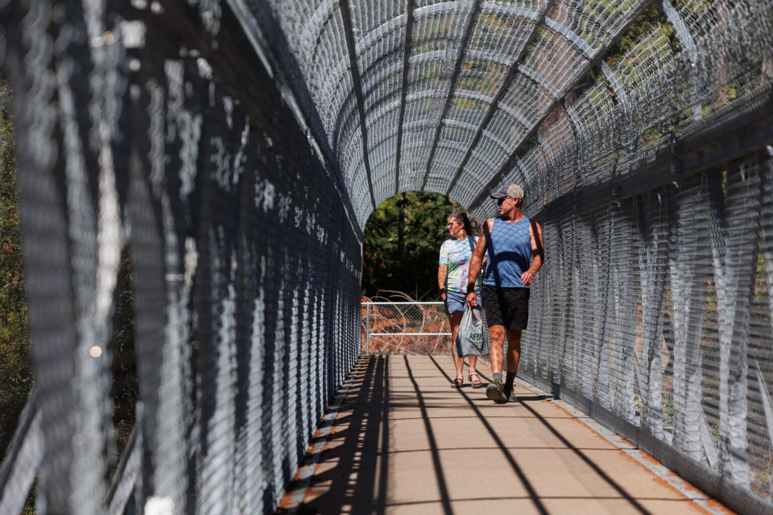 Nick Pate and Melissa Denmark, of Snohomish, walk through the passage between Clayton beach and the Lost Lake parking lot.