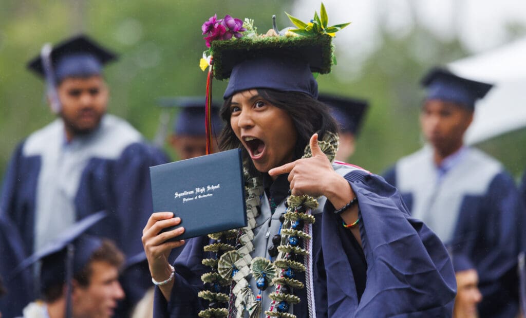 Keona Mendoza shows off their diploma.