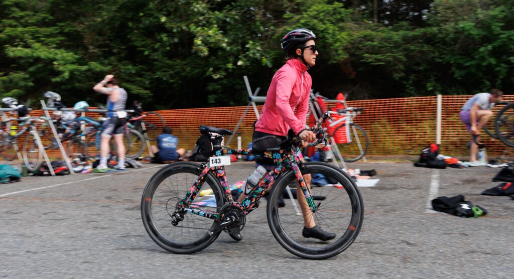 Allison Porter walks her bike out of the transition area.