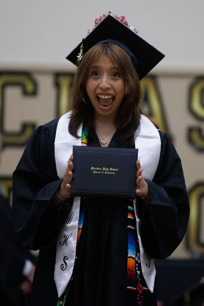 Jetzy Huerta reacts as she shows off her diploma.