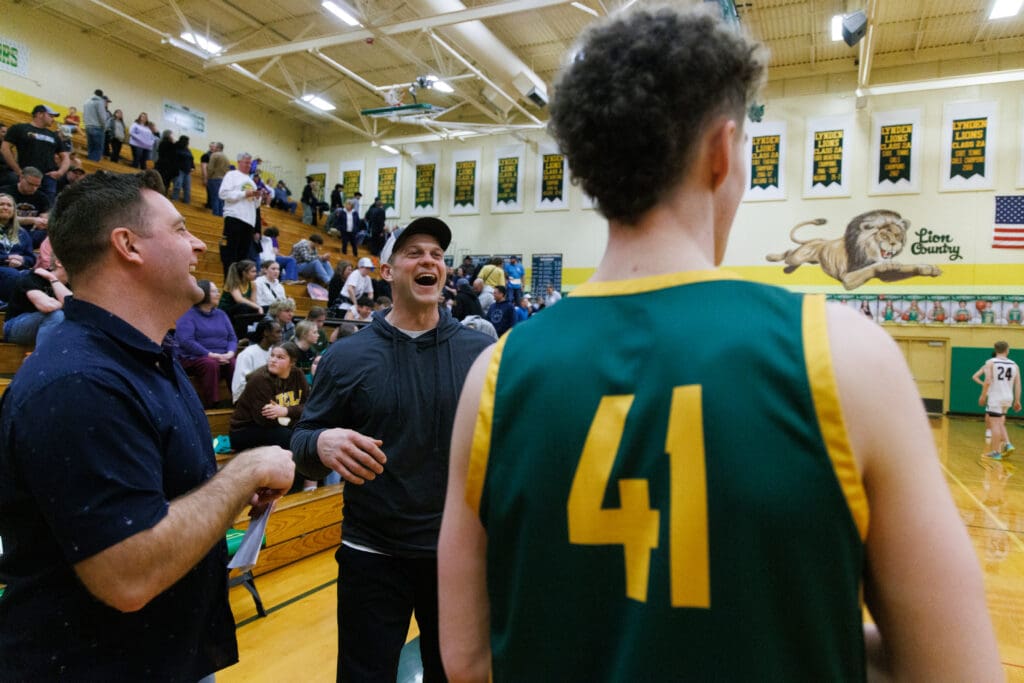 City coaches Aaron Dickson and Jake Locker laugh with Sehome's Grant Kepley during halftime of the boys game.