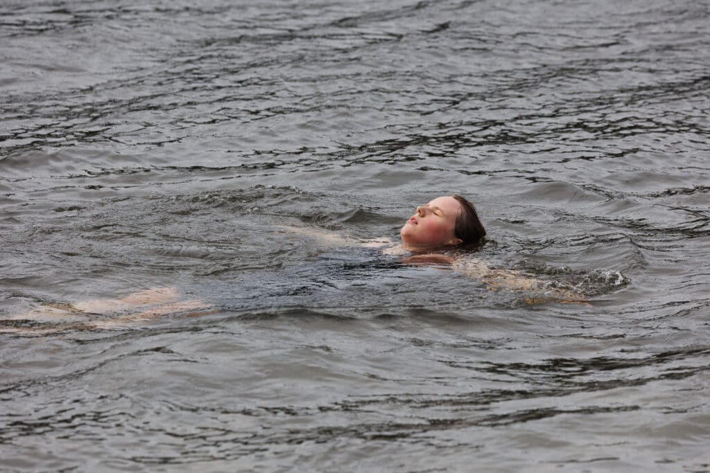 Mairin O’Brien takes a dip in the lake after finishing the Padden Triathlon.