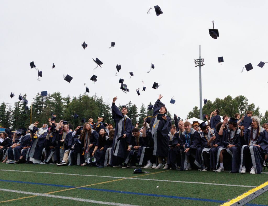 Students toss their caps during the 2023 Squalicum High School graduation ceremony on June 10 at Civic Stadium.