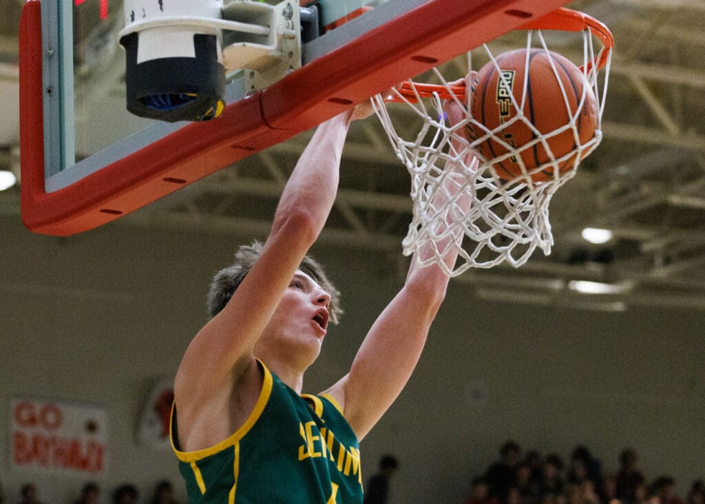 Former Sehome center Grey Garrison reacts as he puts the ball through the net from a dunk.