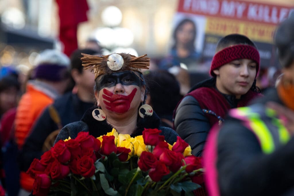 A woman with a painted red handprint