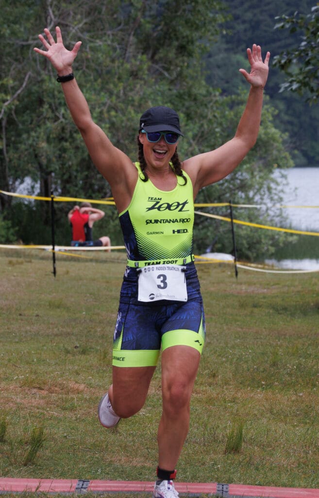 Nicole Gilmore reacts as she crosses the finish line of the Padden Triathlon.