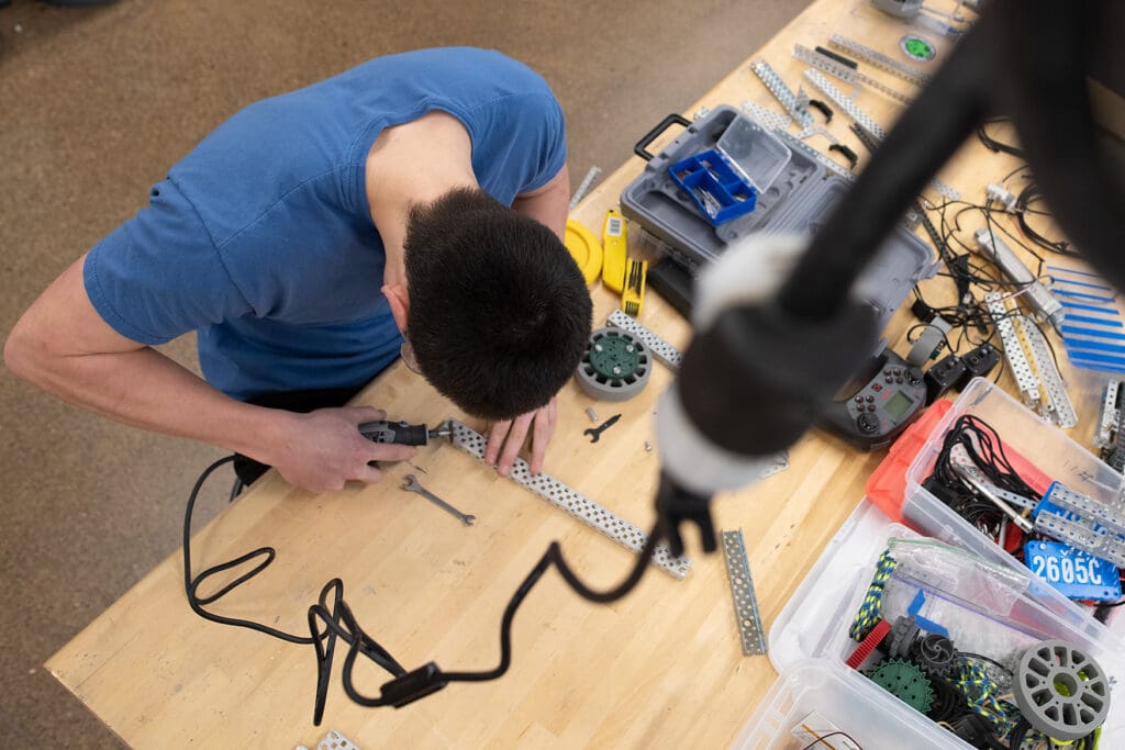 Sehome student Grant Gusukuma uses a Dremel to cut a steel chassis while rebuilding his team's robot Feb. 6 during robotics class at Sehome High School.