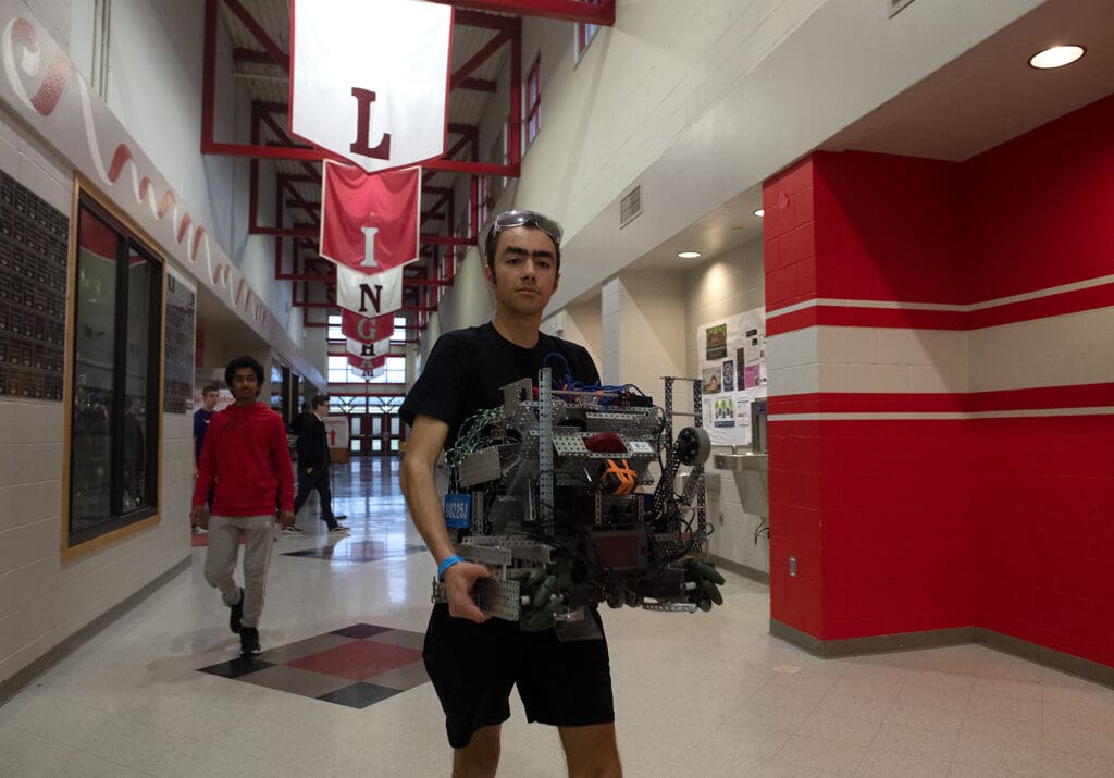 Sam Goldsberry carries his team's robot at the VEX Robotics Competition Feb. 11 at Bellingham High School.