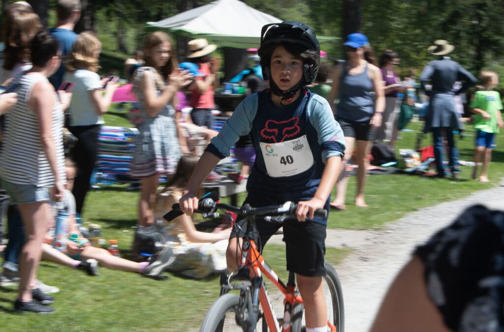 Surrounded by spectators and other racers