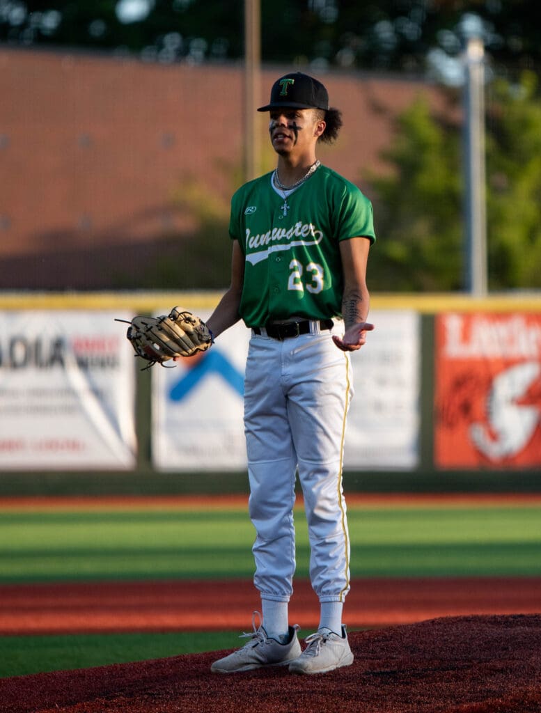 Tumwater senior pitcher Trenton Gaither gestures with his hands in confusion.