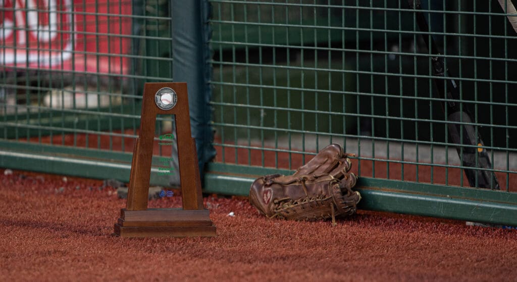 Lynden's second-place trophy sits on the side of the field next to a baseball glove leaning against the metal fence.