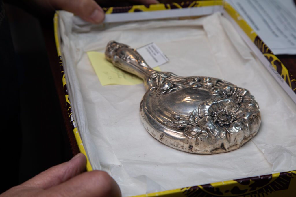 Dave Friedman shows off a silver, heirloom hand mirror in a small tray.