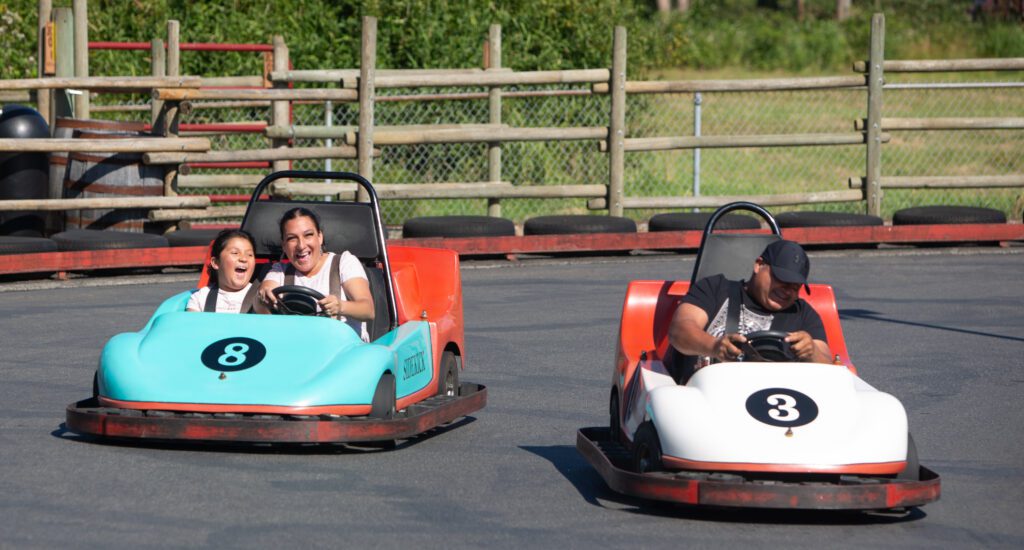 Brooklyn Cendejas, left, laughs as she and her mom, Misty, are passed by her dad Israel on the go-kart track.