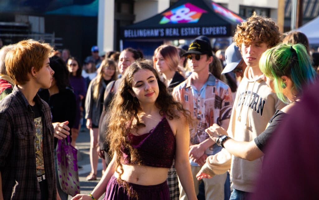 Elodie Vierra, left, Jorden Cleveland, Avery Hocker, and Aili Vanyo make their way to the front of the venue, dancing to the melodies of the music.