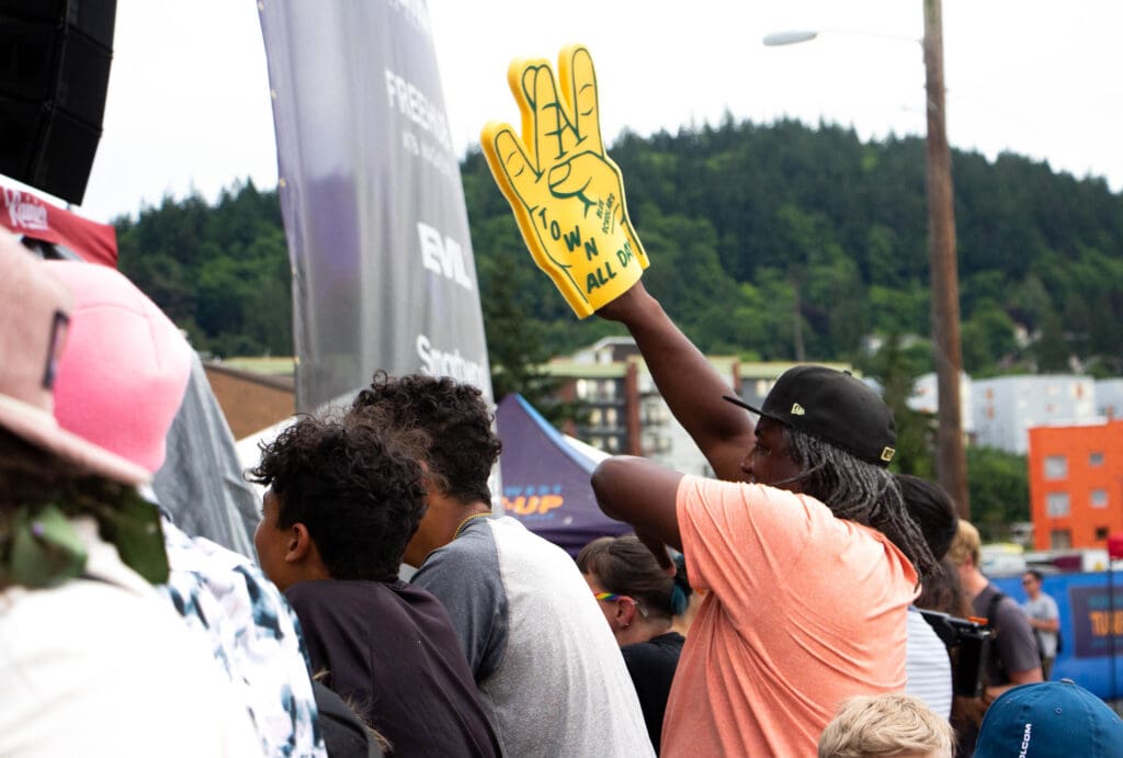 Damian Kirby waves a foam finger as Travis Thompson performs his song