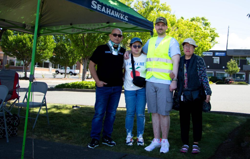 From left, Andy Aguinaldo, Abby Tullius, Joshua Tullius and Marilyn Aberilla stand next to their set up of a canopy with water and resources for the search party.