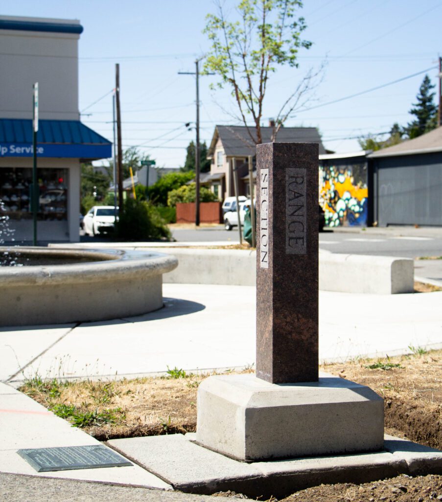 A monument installed in 1985 commemorates the 1785 invention of the rectangular survey system sits near a fountain.