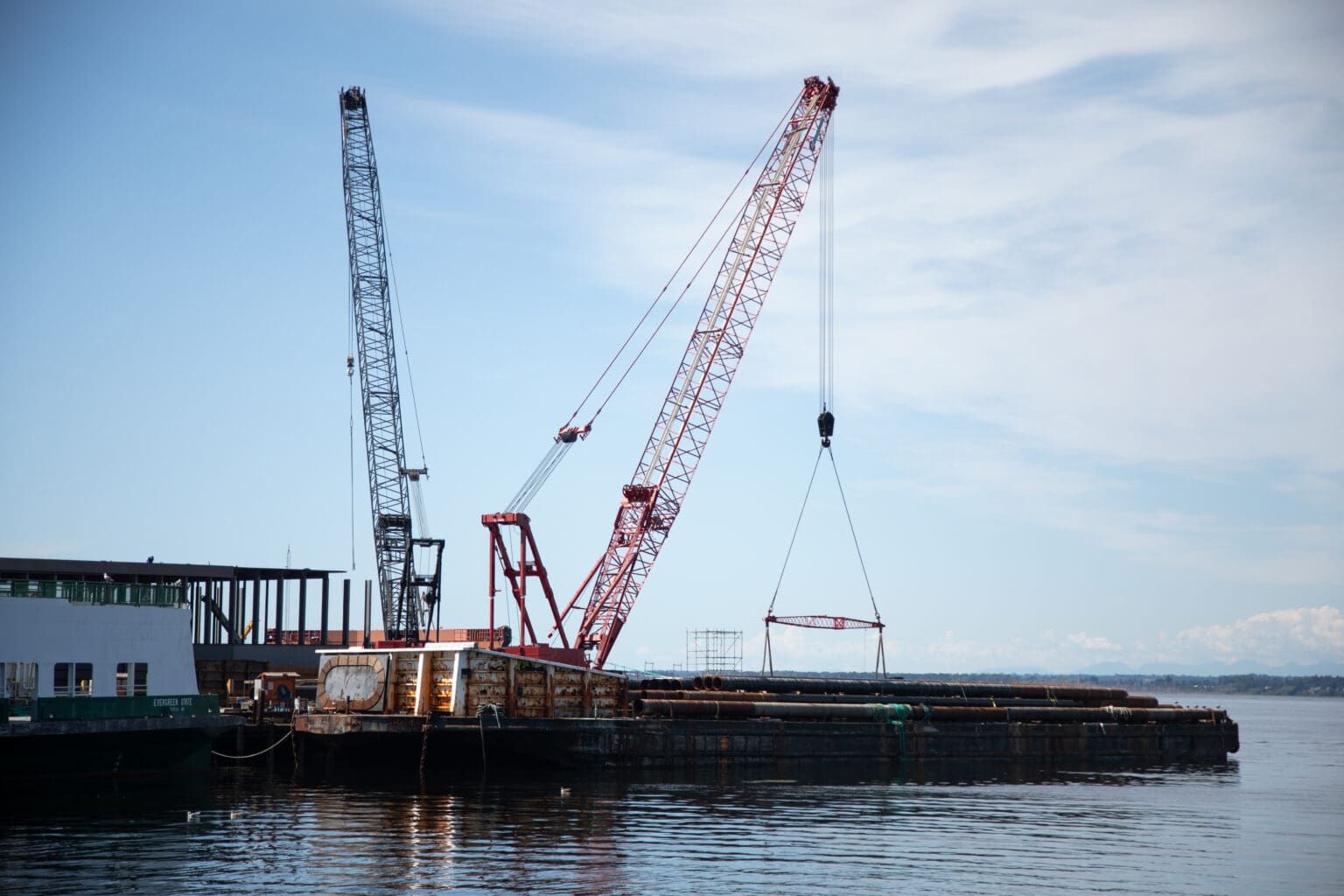 The crane barge off the southern shore of Bellingham Bay hangs over the water.