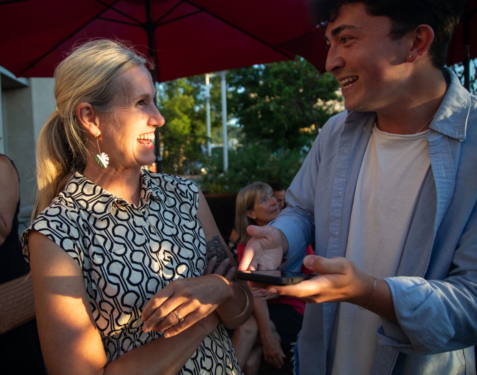 Kim Lund chats with her campaign manager, Davin Rose, as he gestures with a phone in hand.