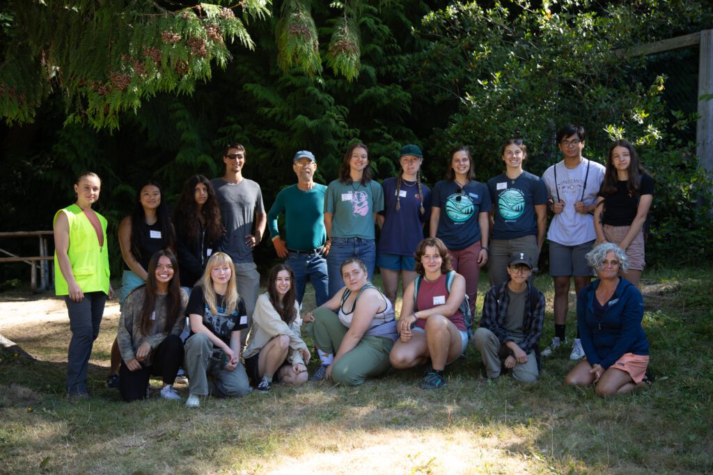 Participants in the RE Source's Youth Climate Summit pose for a camera with wide smiles.